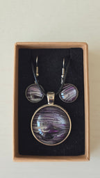 Handgefertigtes Schmuckset Solas Purple Sands mit runder Halskette und passenden Ohrringen in Violett-, Flieder- und Silbertönen mit feiner, sandähnlicher Linienstruktur.