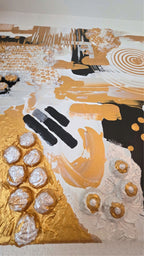 Abstraktes Leinwandbild Aurea 50 × 50 cm mit Gold, Schwarz, Weiss und Perlmutt, geometrischen Formen, Kreisen und plastischen Strukturen.