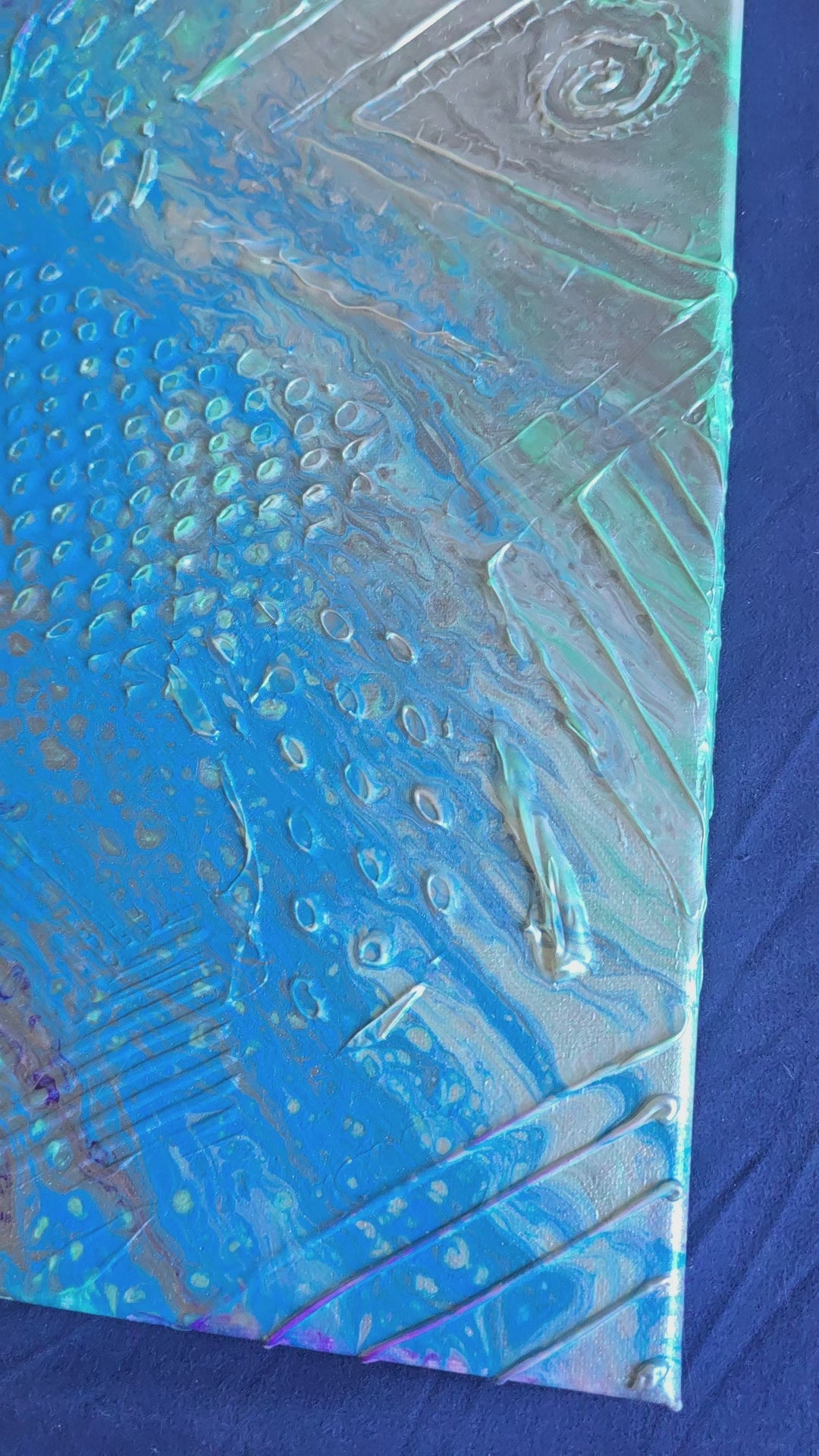 Quadratisches abstraktes Leinwandbild mit strukturierter Oberfläche, kräftigem Blau, Türkis, Violett und Silber sowie Punkten, Linien und Kreisformen.