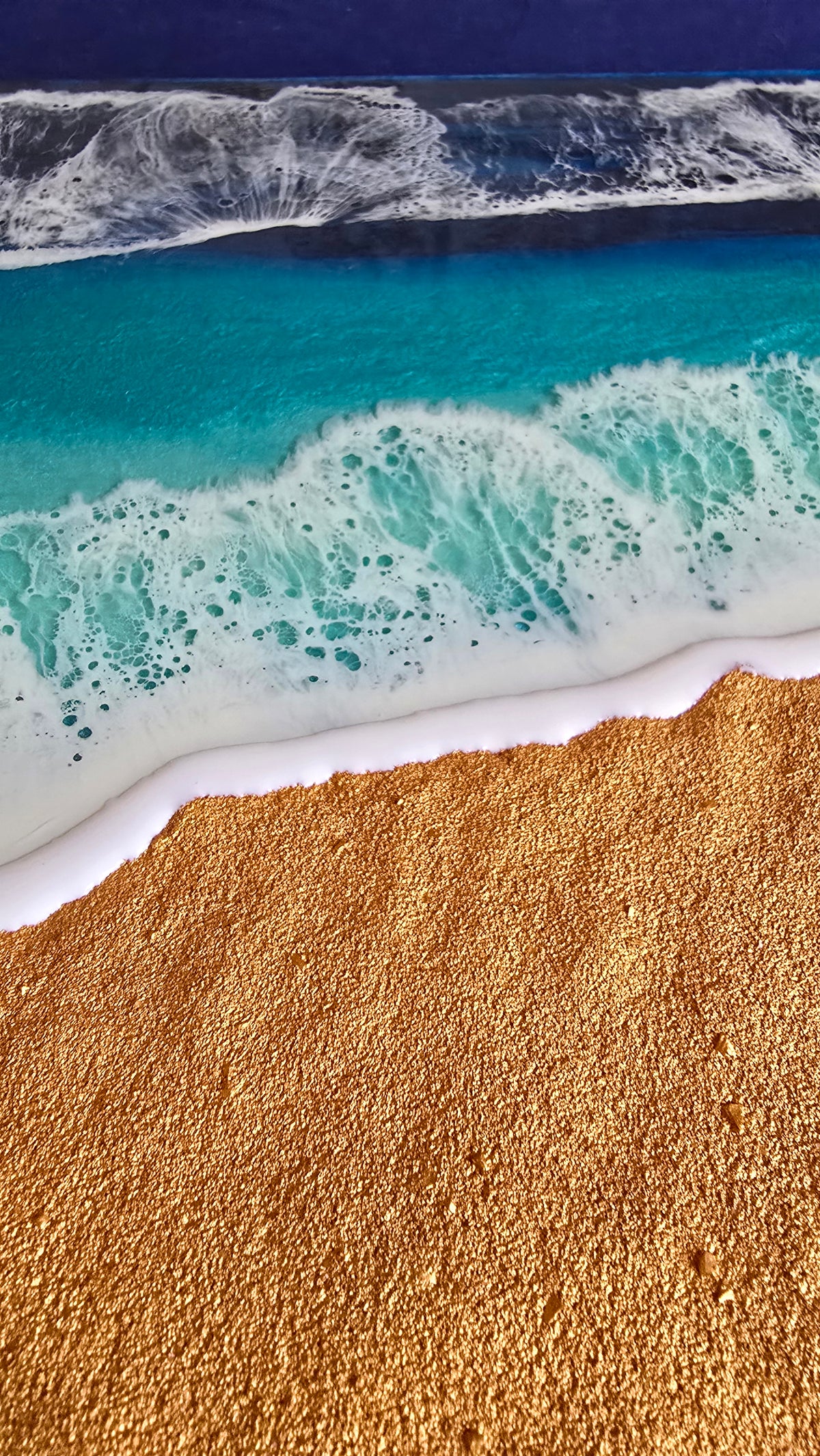 Handgefertigtes Resin-Meeresbild «Solas Shoreline» mit türkisfarbenem Wasser, schäumender Brandung und strukturiertem goldenen Strand auf einem 40 × 40 cm Gesso-Rahmen.